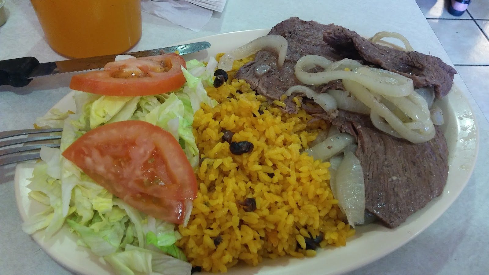 Plate with yellow rice and salad